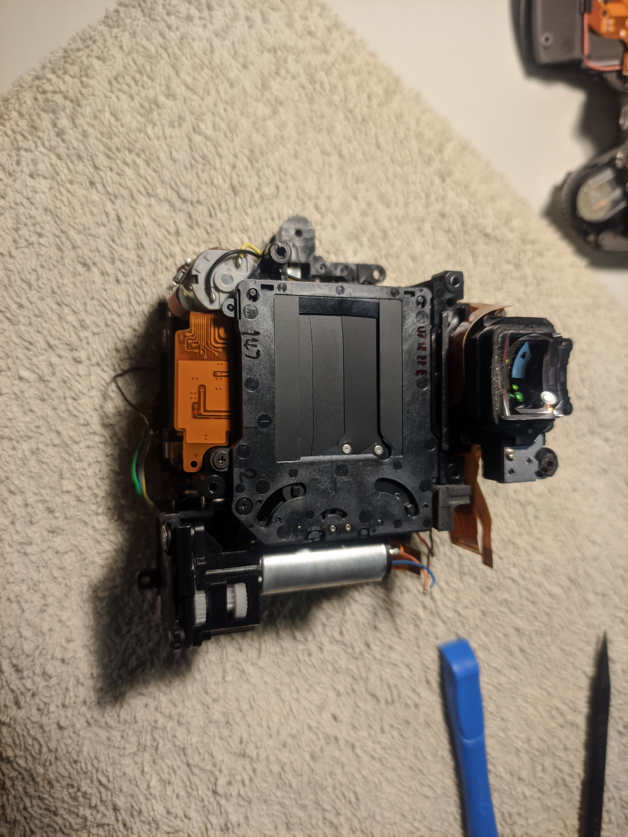 A photo of the front part of the internal assembly, which contains, among others, the shutter and the viewfinder. The part I plan to fix is somewhere in there too.